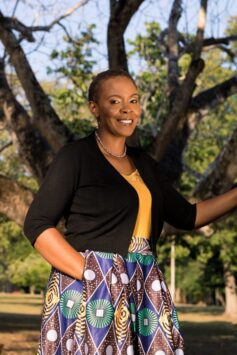 Desi-Ann Gordon, The VA Mom standing by a tree