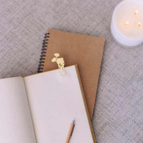 journals and candle on neutral surface